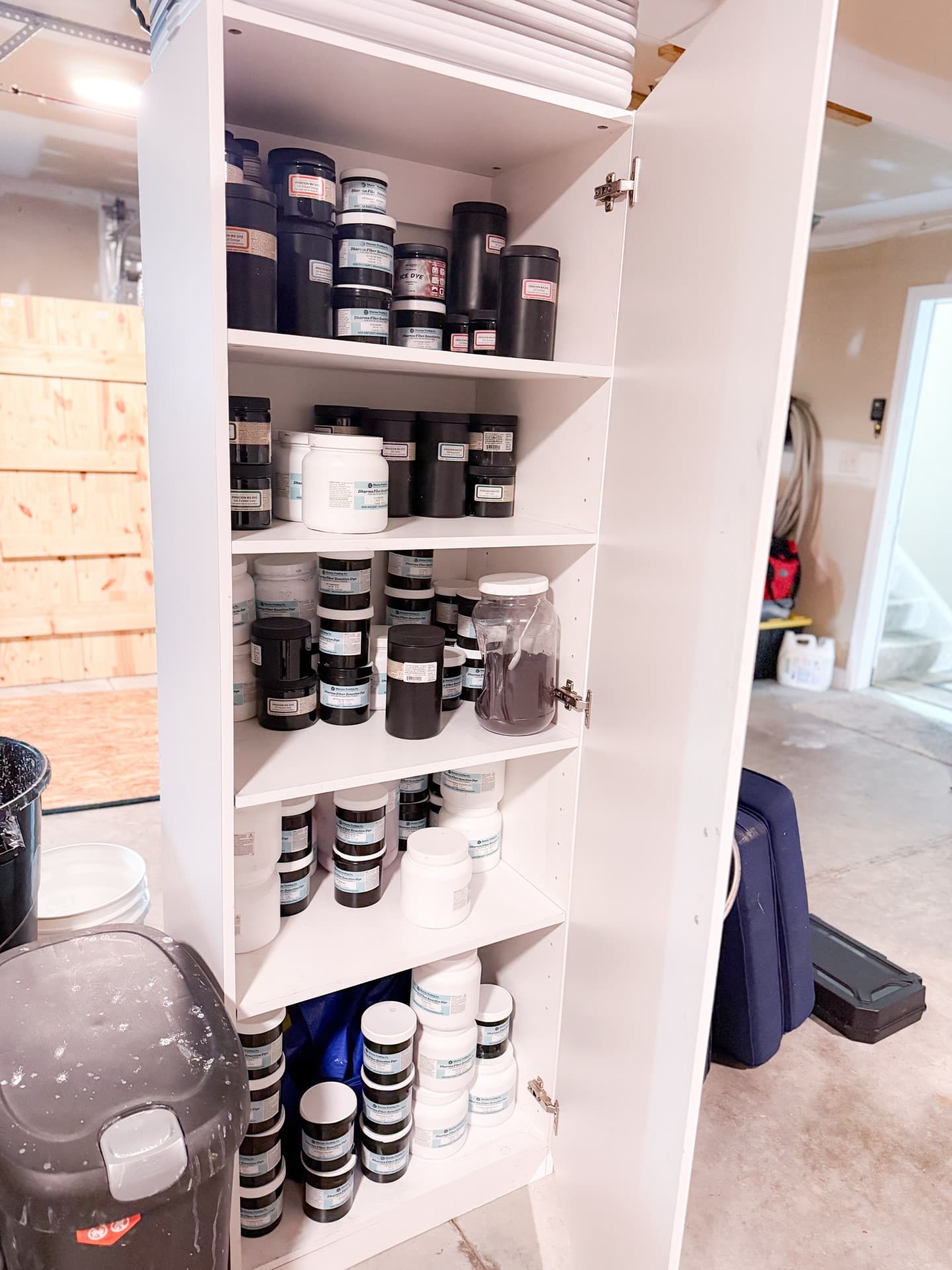 Procion MX dye jars organized in the Floorboard Findings studio cabinet